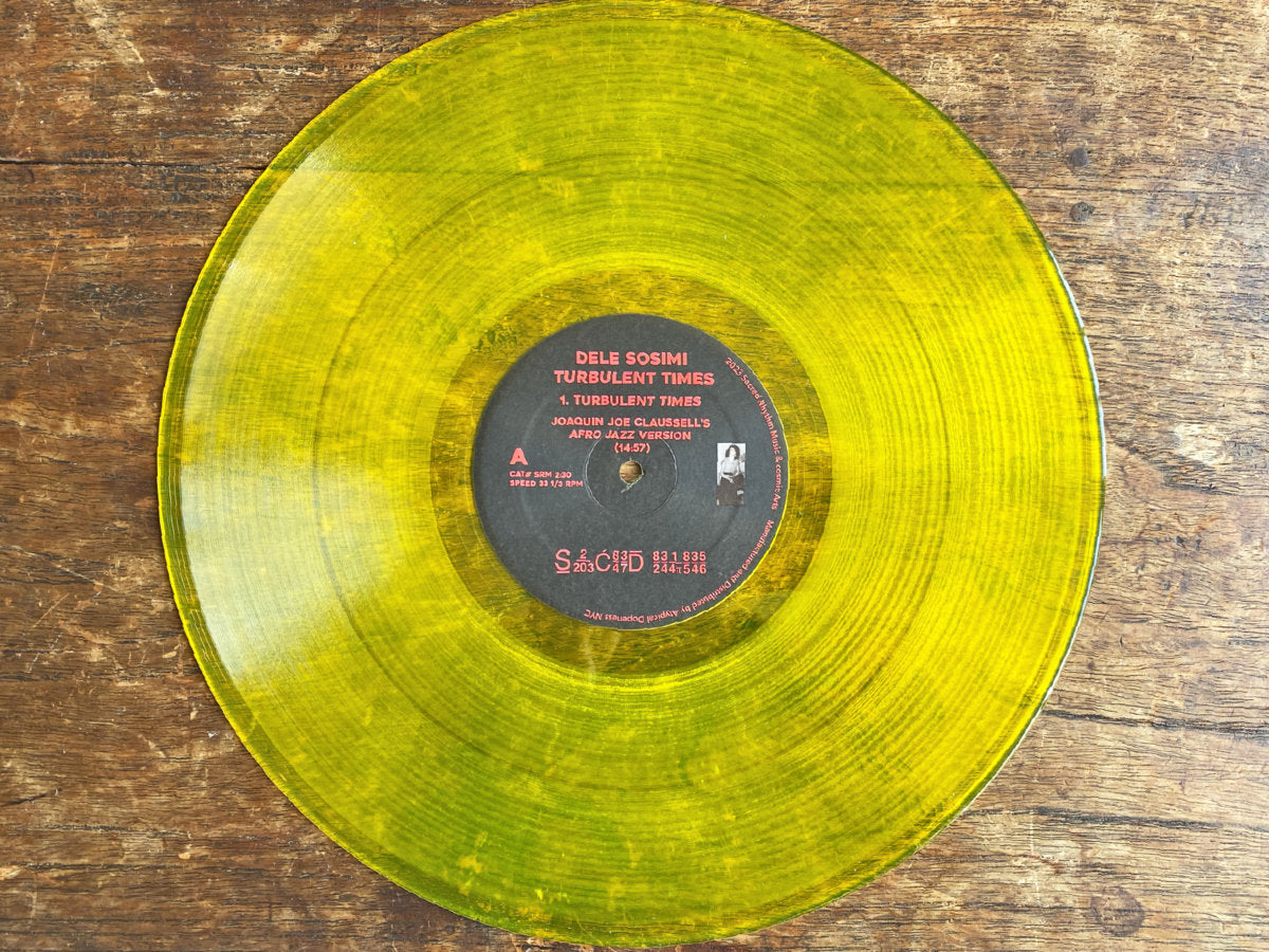 Lado A del vinilo Dele Sosimi – Turbulent Times (Remixes By Joaquin Joe Claussell), 12" amarillo translúcido con etiqueta central, versión Afro Jazz de 14:57 en Sacred Rhythm Music.