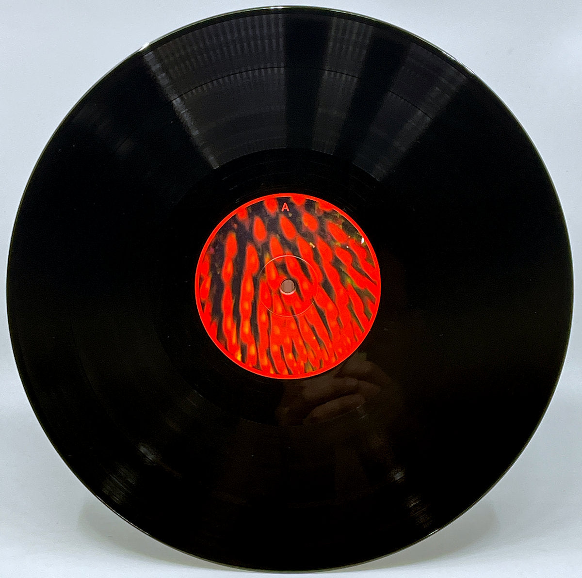 Etiqueta central lado A del vinilo Fila Brazillia – Maim That Tune con diseño rojo abstracto, parte de la reedición doble LP remasterizada.