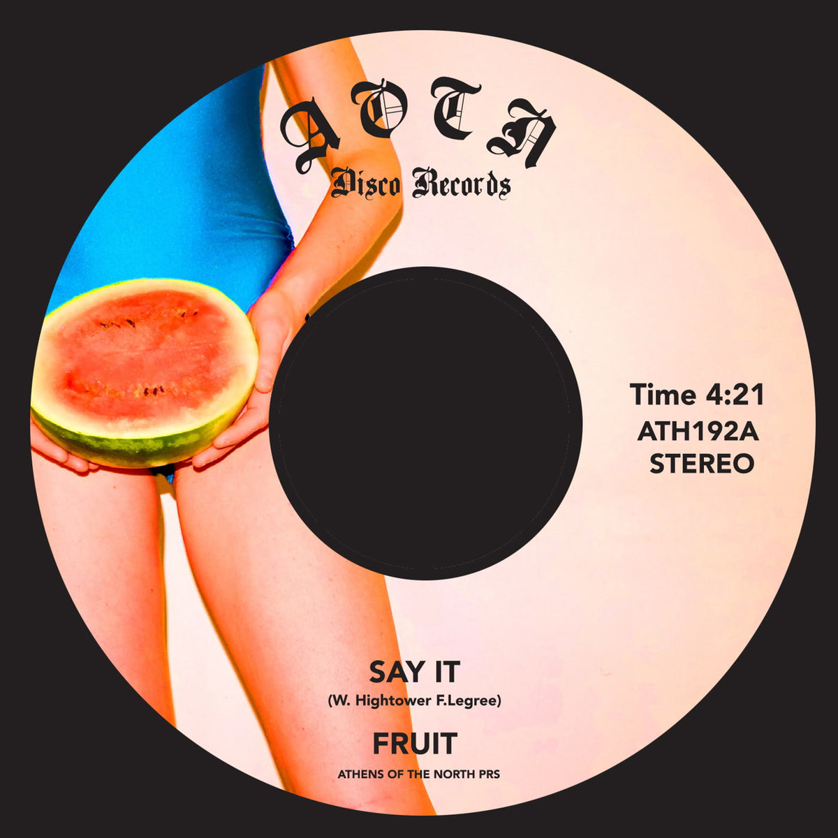 Etiqueta central del vinilo Fruit – Say It de Athens Of The North, formato 7" 45 RPM, muestra arte colorido con una persona sosteniendo una sandía, créditos visibles y número de catálogo ATH192A.