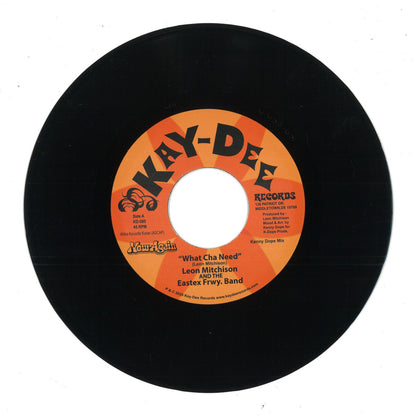 Etiqueta central del vinilo 7" de Leon Mitchison & the Eastex Freeway Band – What Cha Need, lado A, con diseño naranja de Kay-Dee Records y detalles de pista, duración y créditos.