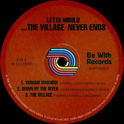 Etiqueta del lado B del vinilo Letta Mbulu – In The Music... The Village Never Ends de Be With Records. Texto impreso: lista de 3 canciones y logo de Be With Records.