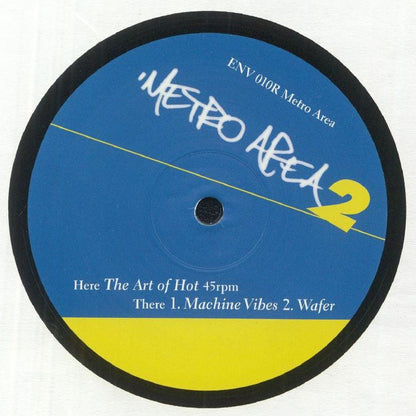 Portada del vinilo Metro Area – Metro Area 2, lanzado por Environ en formato 12". Diseño en azul y amarillo con el logo de la banda. Texto impreso: “The Art of Hot”, “Machine Vibes” y “Wafer” indicando la lista de canciones.