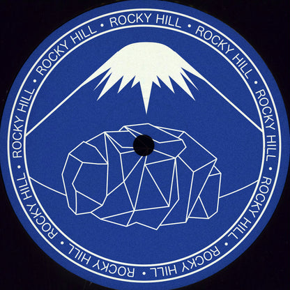 Lado B del vinilo Paul West – Blue Sun 12" EP Rocky Hill, label azul con arte geométrico Rocky Hill y montaña.