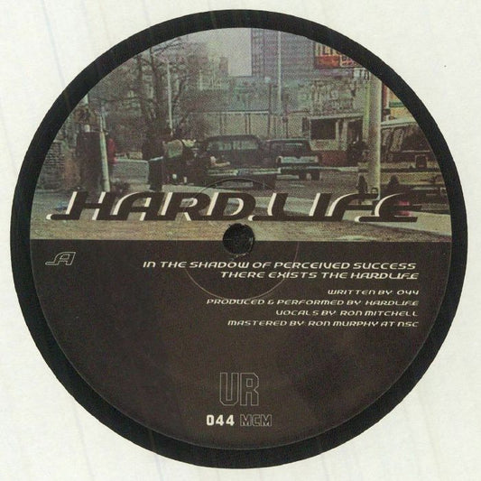 Lado A del vinilo UR – Hardlife, reedición 12" de Underground Resistance con arte urbano, cita impresa, créditos y catálogo 044 MCM en etiqueta central.