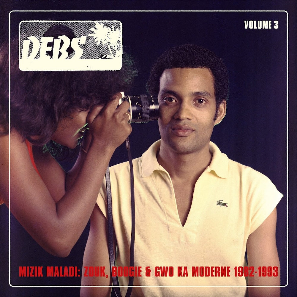 Portada delantera del vinilo V.A. – Mizik Maladi: Disques Debs International Vol. 3, publicado por Strut. Diseño retro con fotografía vibrante.