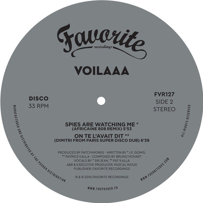 Lado B del vinilo Voilaaa – On Te L’Avait Dit / Spies Are Watching Me (Remixes), etiqueta gris con dos remixes y 33 RPM.